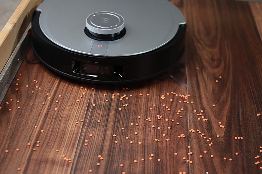 The Ecovacs Deebot X1 OMNI vacuums dirt along the skirting boards